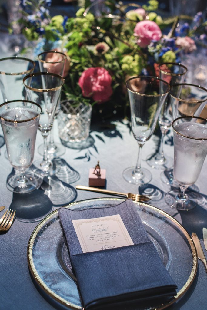 place setting blue and gold . gold rim glasses